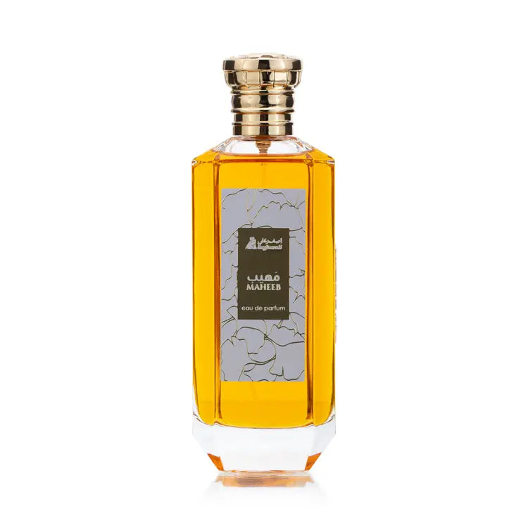A bottle of Maheeb Eau de Parfum with a yellowish liquid inside, featuring a floral design on the label and a golden cap.